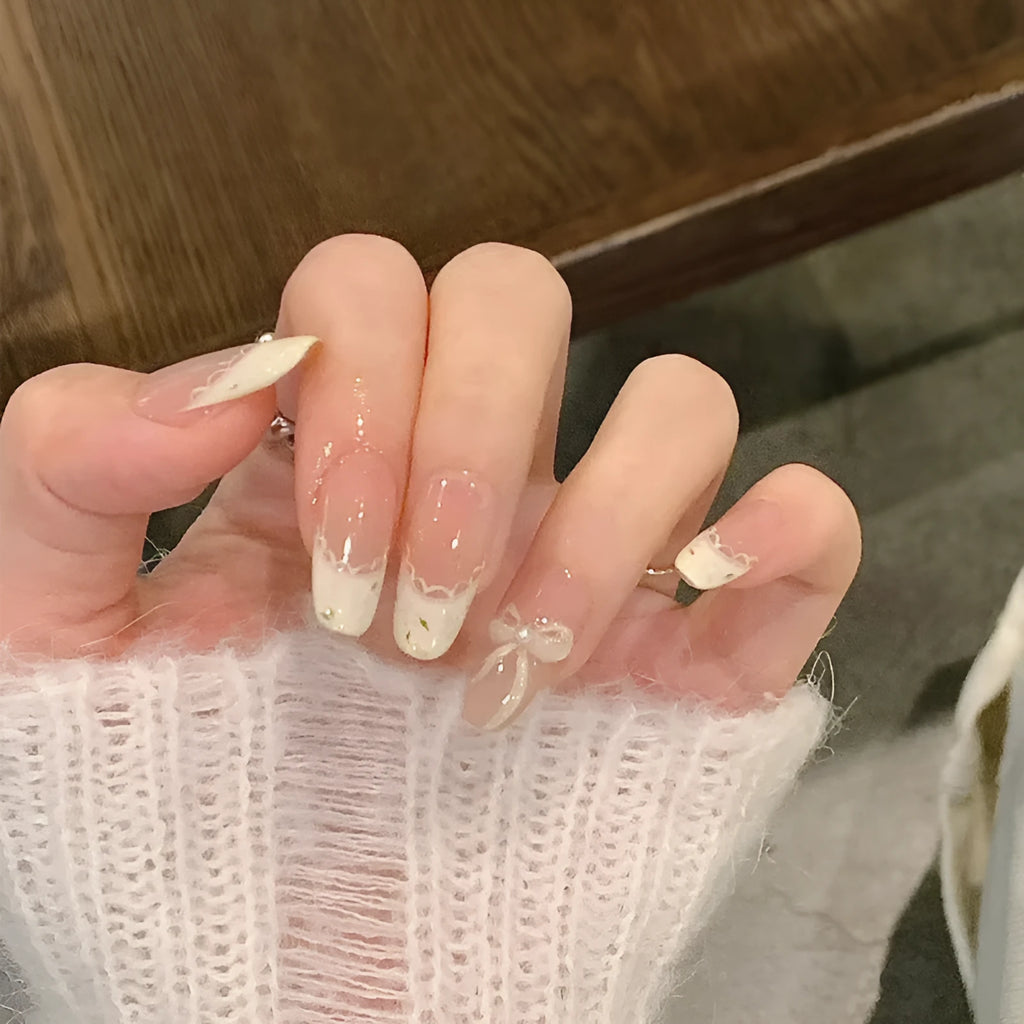 Pack of sweet girl style fake nails showing random colour designs in a set of ten.