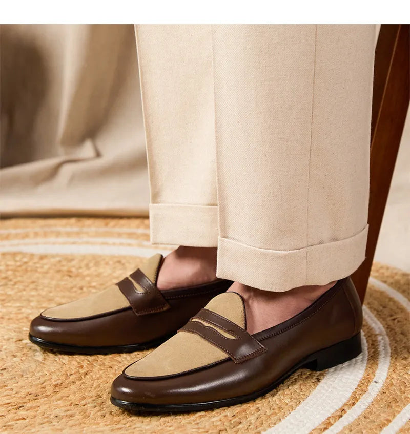 Coffee grey suede leather loafers with an elastic kick tab closure and a rubber sole.