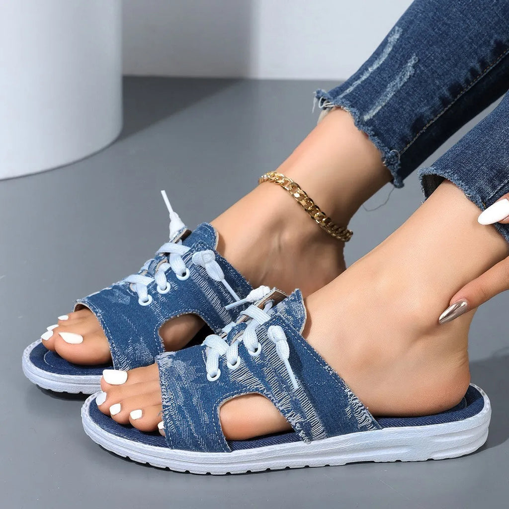 Blue Roman style women's canvas slippers with cloth upper and rubber sole.