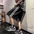 Men's loose-fitting track pants in black with micro-elastic construction and sports style design