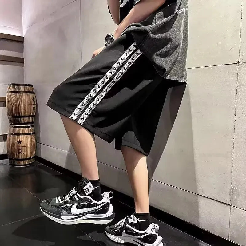 Men's loose-fitting track pants in black with micro-elastic construction and sports style design