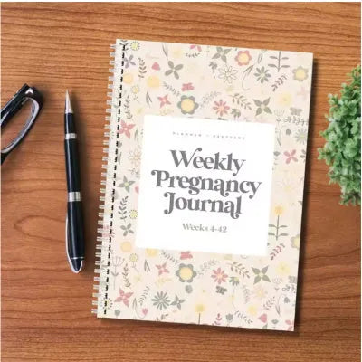 A5 weekly pregnancy diary notebook open to show weekly tracking pages
