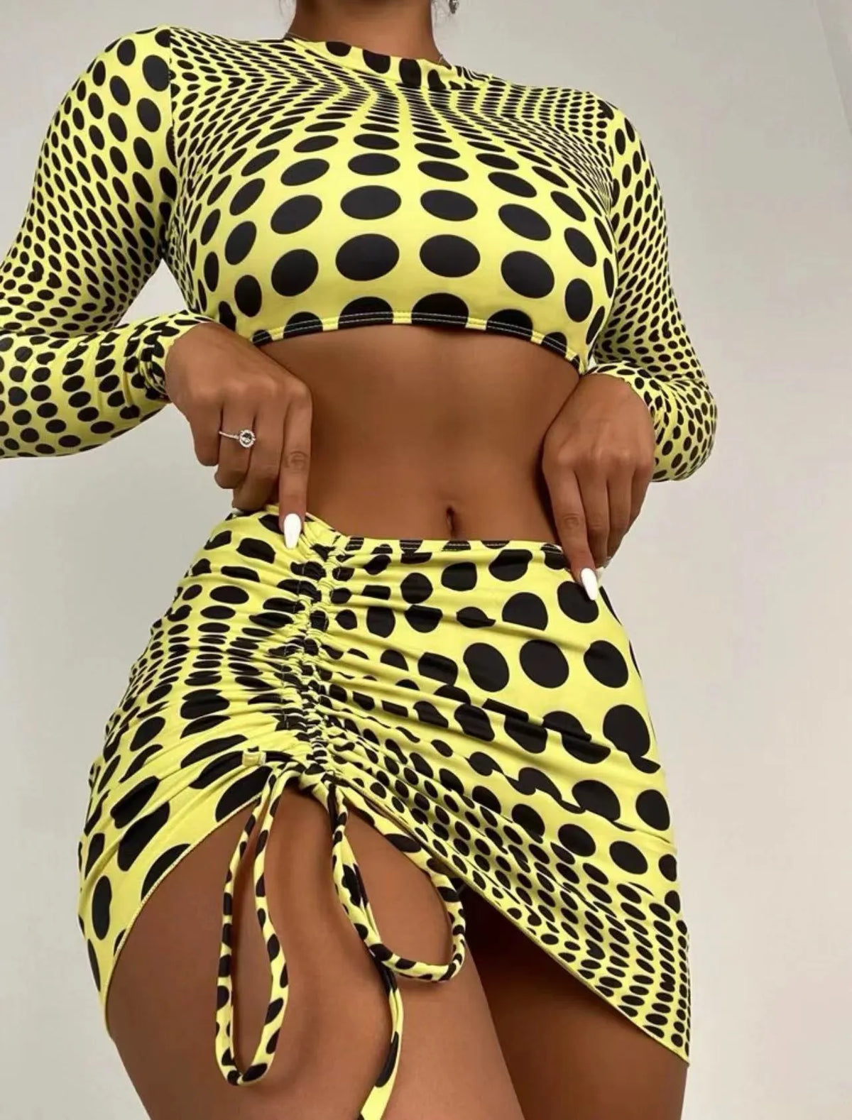 Women's green or yellow polka dot polyester swimsuit three-piece set with swim top, skirt, and bra