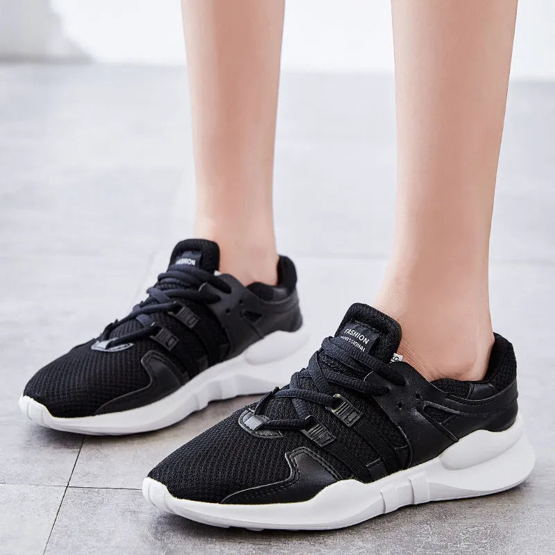 Casual mesh sneakers with hollow-out breathable design and round toe in black and white colour options