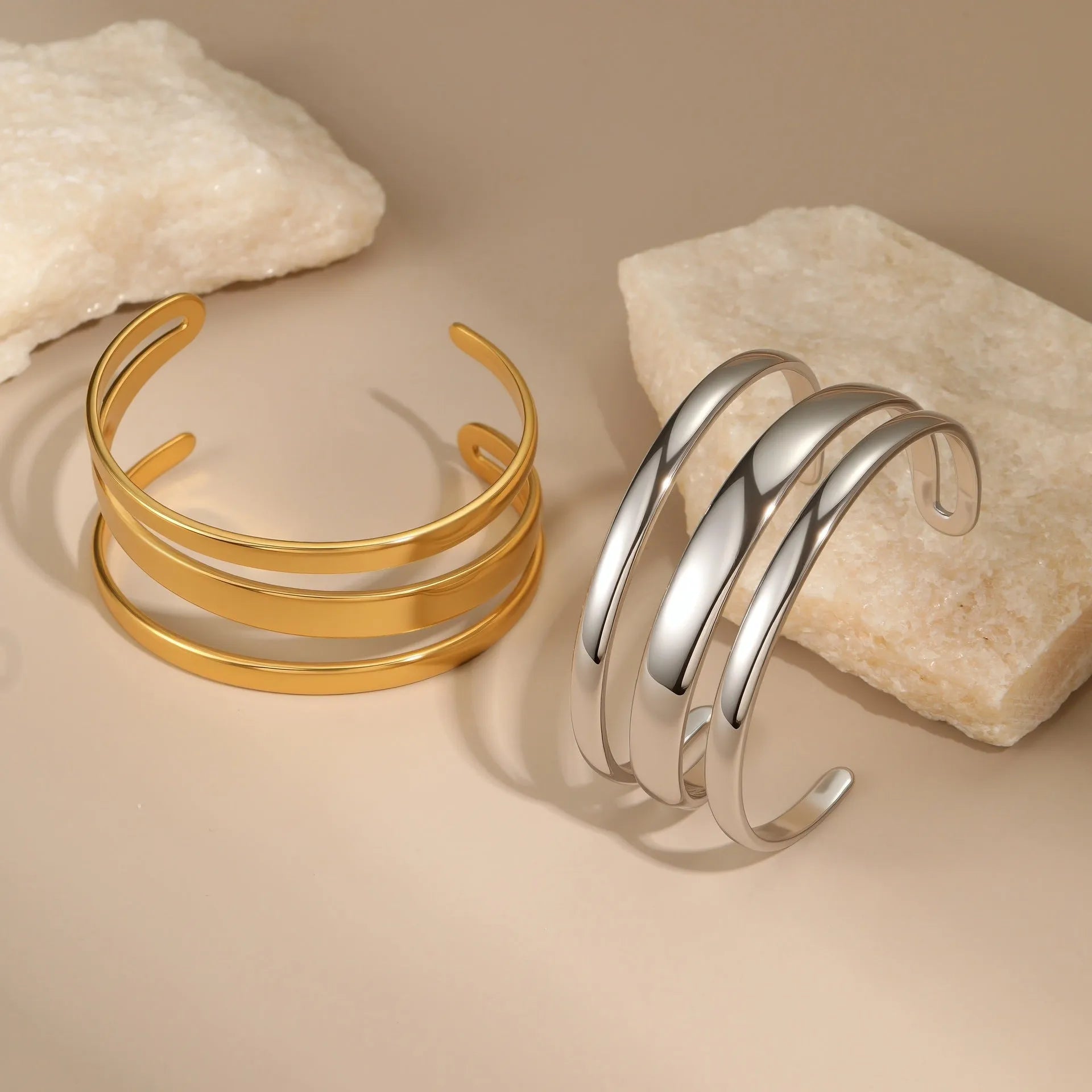 A geometric line design bracelet for women on wrist, shown in stainless steel with a simple opening clasp.