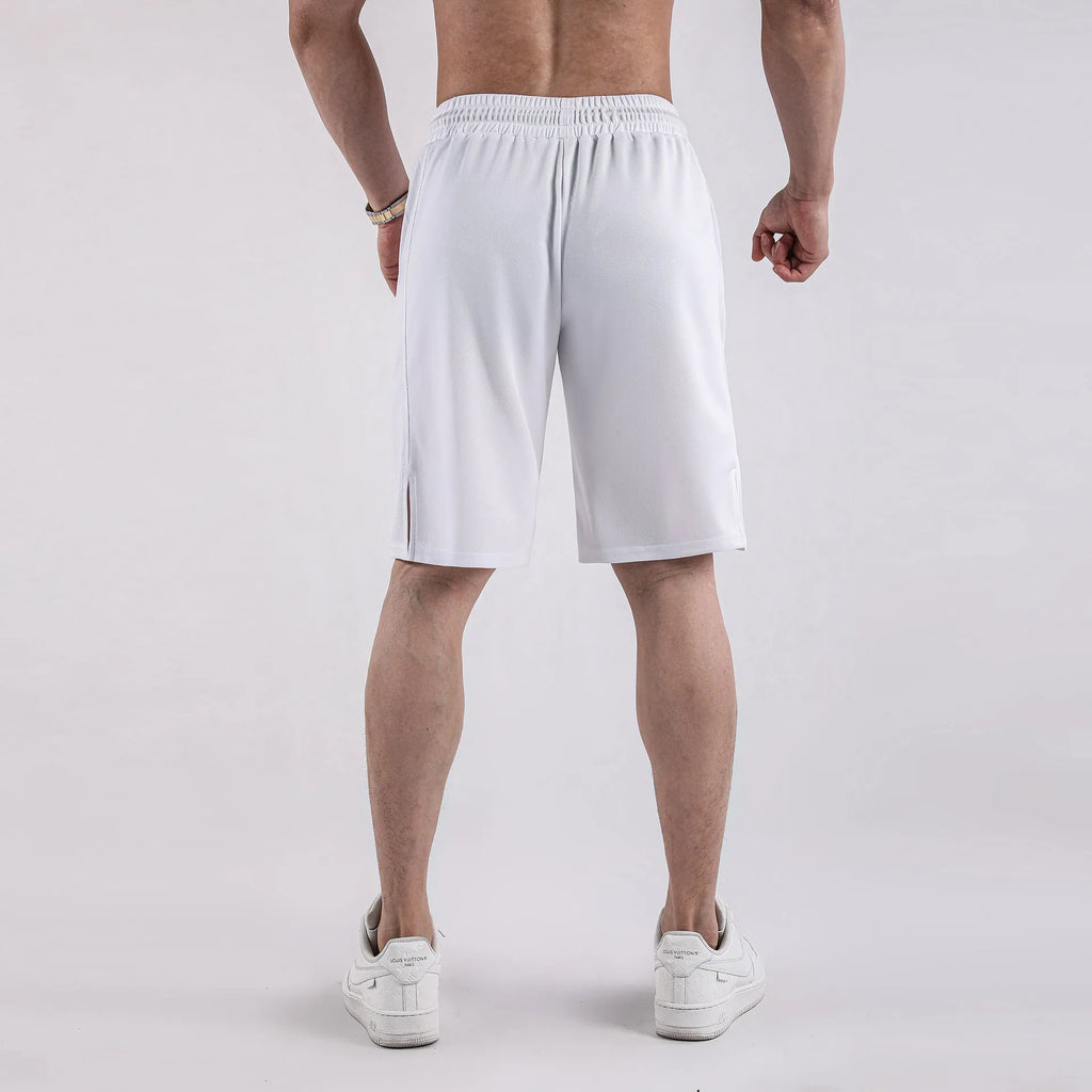 Man wearing loose black capri-length fitness shorts with an elasticated waistband.