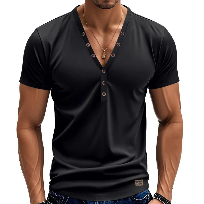 Man wearing a loose fit grey v-neck pullover top with button detail on the neckline
