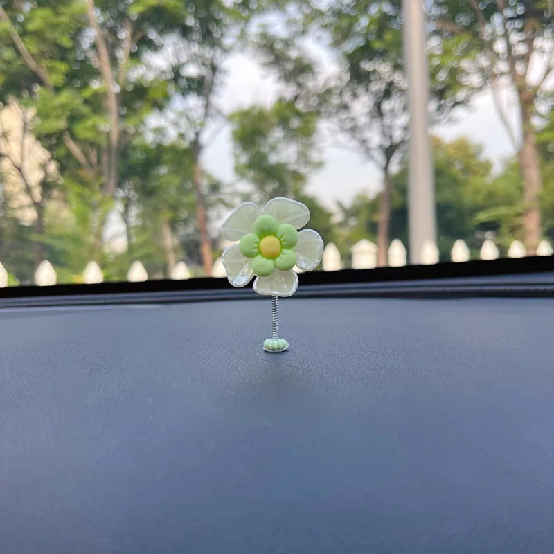Small blue plastic swing-shaped car dashboard decoration.