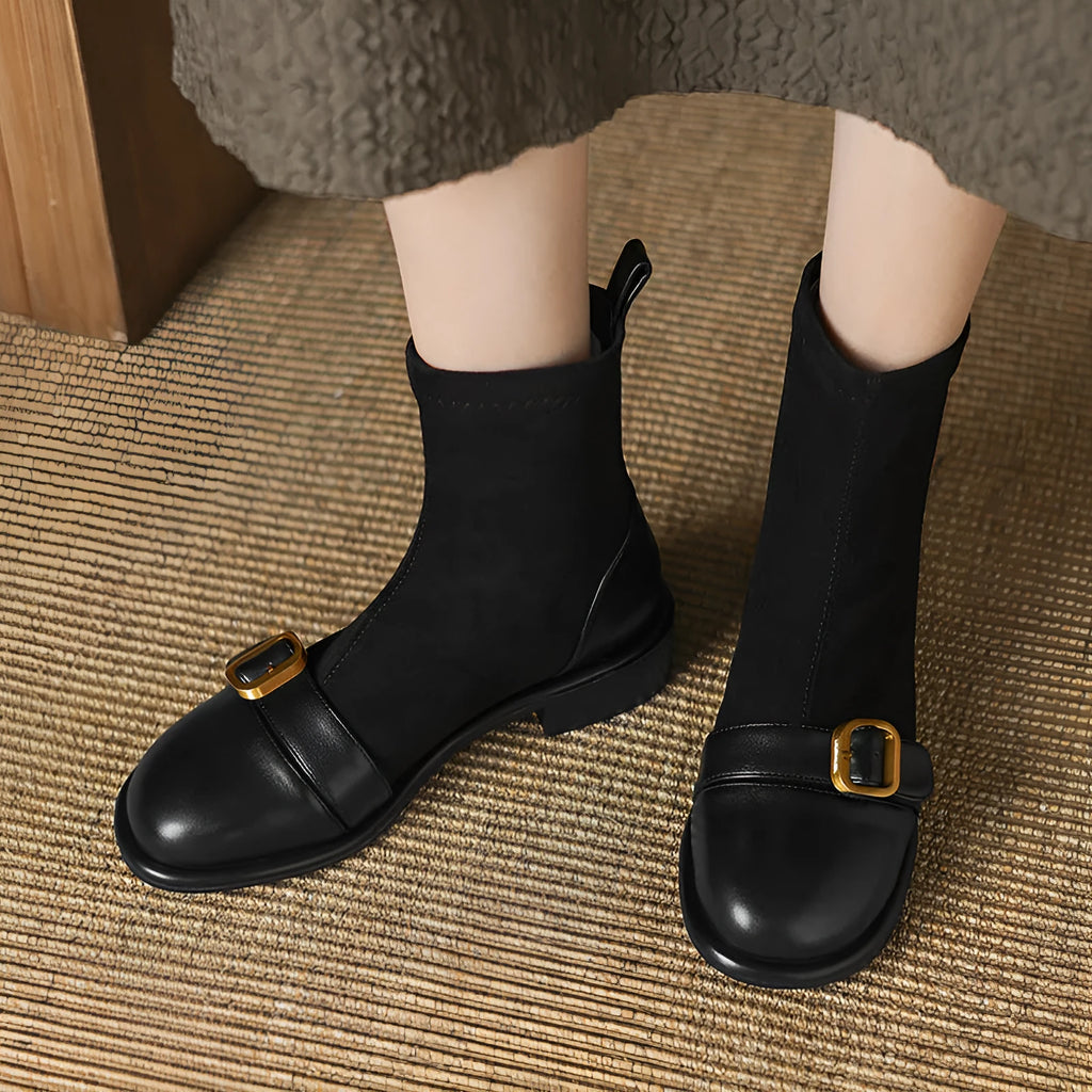 Women's black low heel ankle boots with martin-style buckle stitching and white lace-up front.