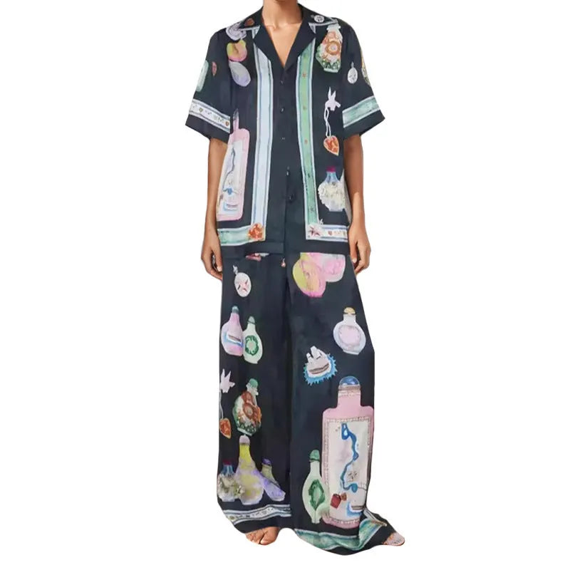 Black women's casual set with cartoon pattern, featuring a short sleeve cardigan and matching trousers.