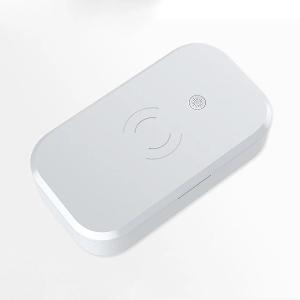White ultraviolet disinfection box with wireless charging pad for mobile phones and nail tools