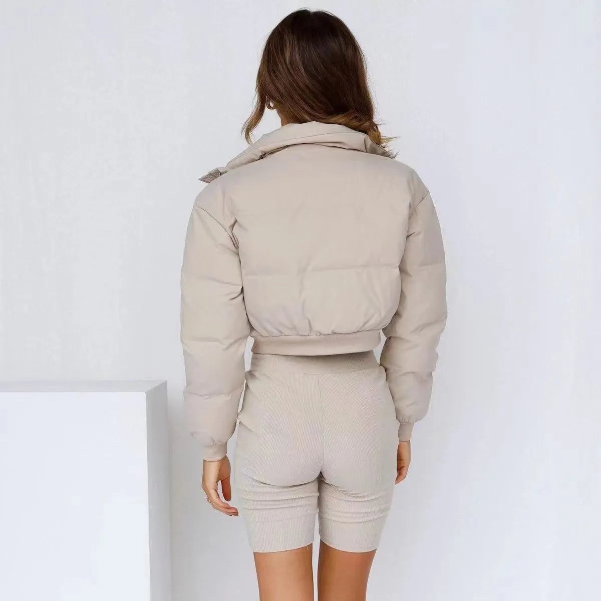 Women's loose blue polyester jacket with long sleeves on a hanger