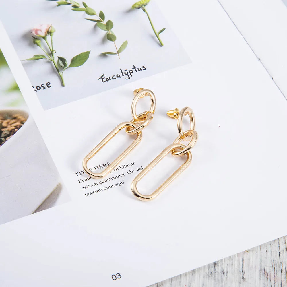 Sterling silver geometric hoop earrings with ring and line design elements
