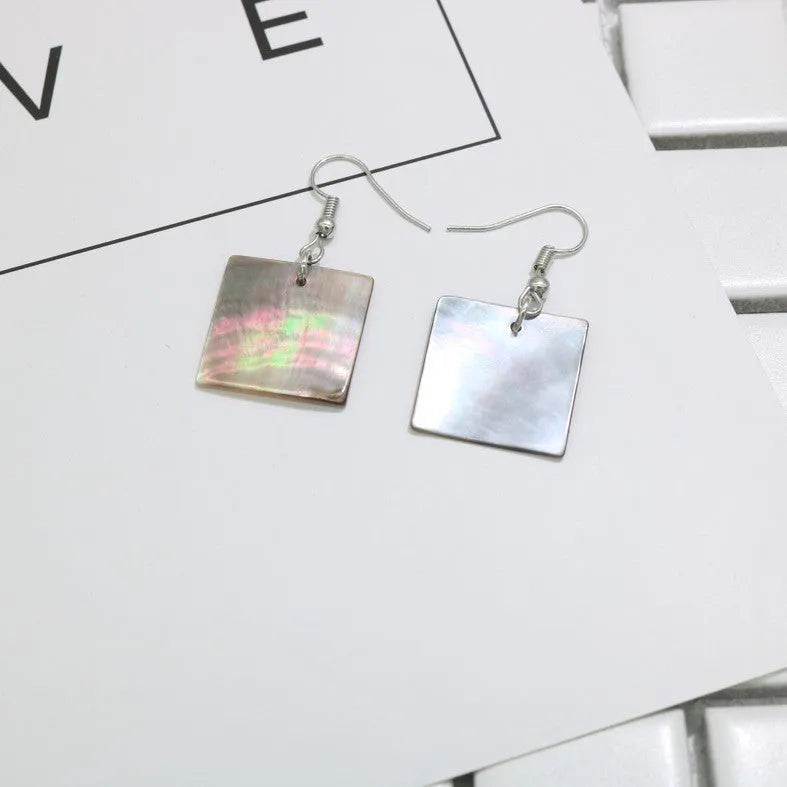 Geometric shell earrings in square panther or rectangular shell styles with natural material texture