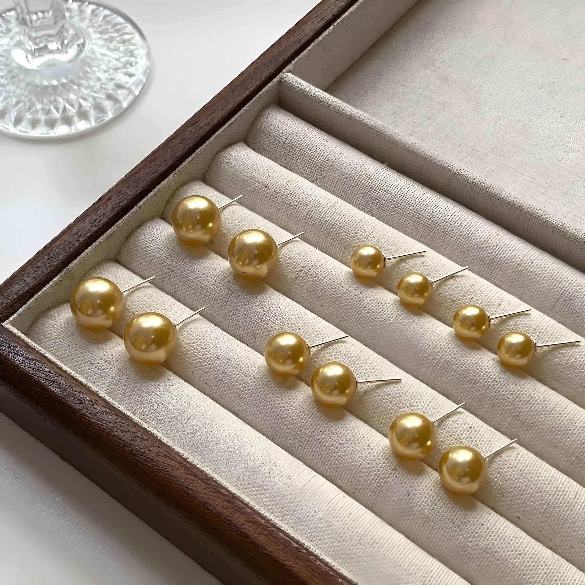 Large geometric pearl stud earrings for women in silver, showing eight-point star detail on setting.