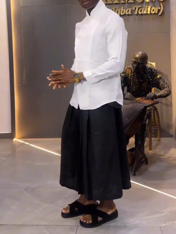 White asymmetric long sleeve shirt paired with black pleated pants in a women's casual two-piece set.