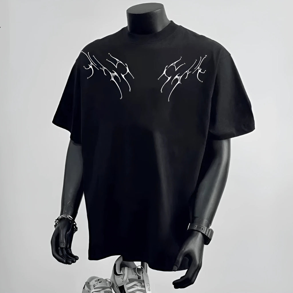Man wearing a loose-fit black cotton T-shirt with a white printed letter design on the front.