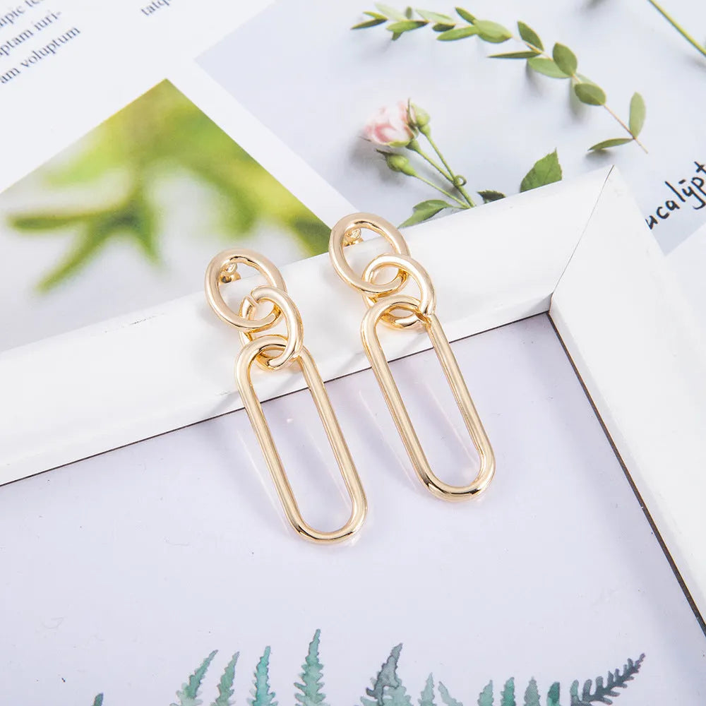 Sterling silver geometric hoop earrings with ring and line design elements