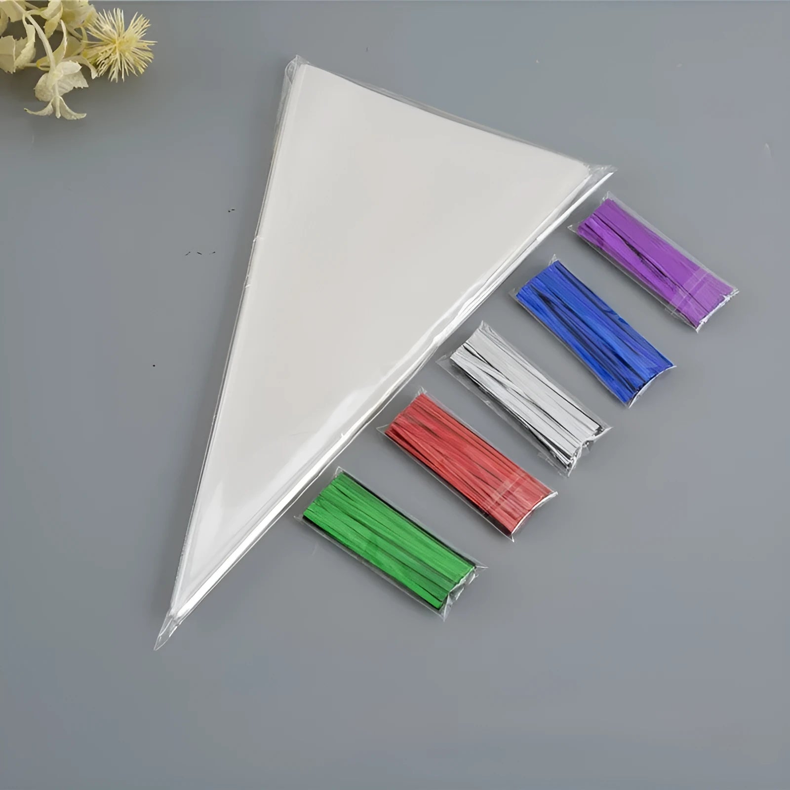 Clear triangular plastic packaging bags with wire ties in three different sizes