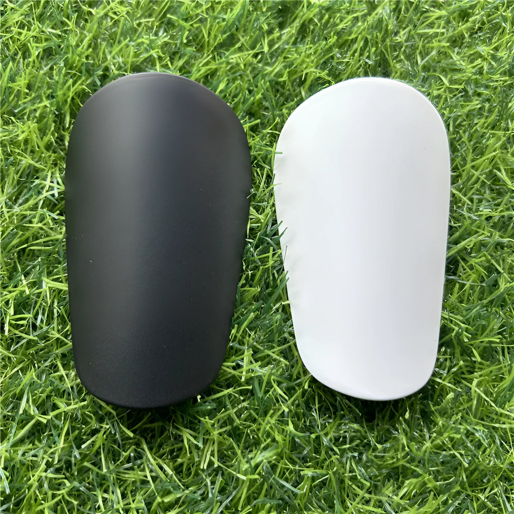 Extra small mini football shin guards in black and white measuring 8cm by 5cm