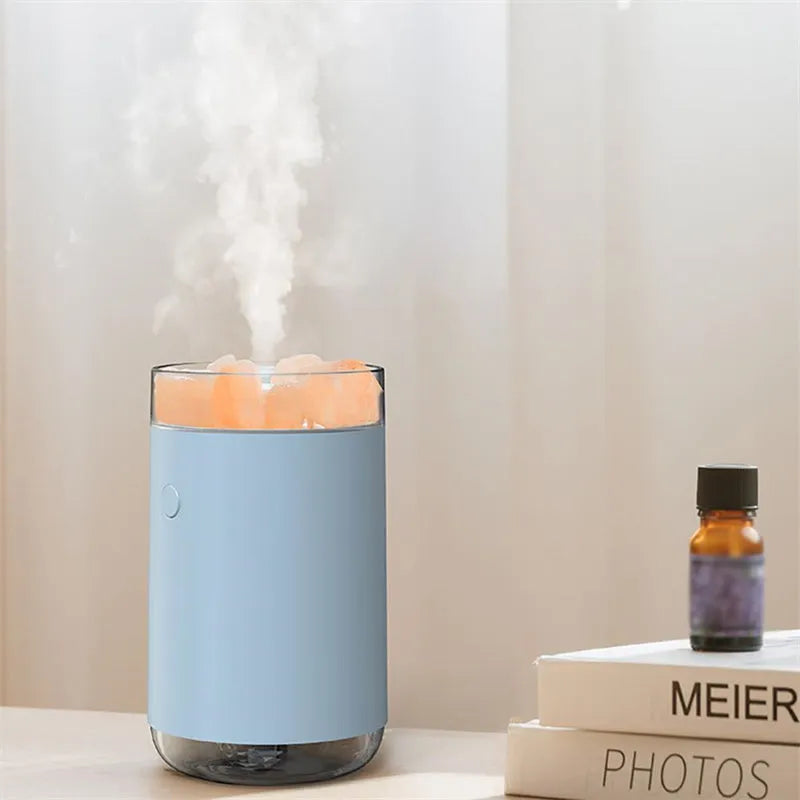 Ultrasonic aromatherapy diffuser humidifier with natural crystal salt stone and LED lamp in blue, showing mist and light