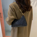 Brown pleated chain baguette shoulder bag showing vertical square shape and adjustable strap