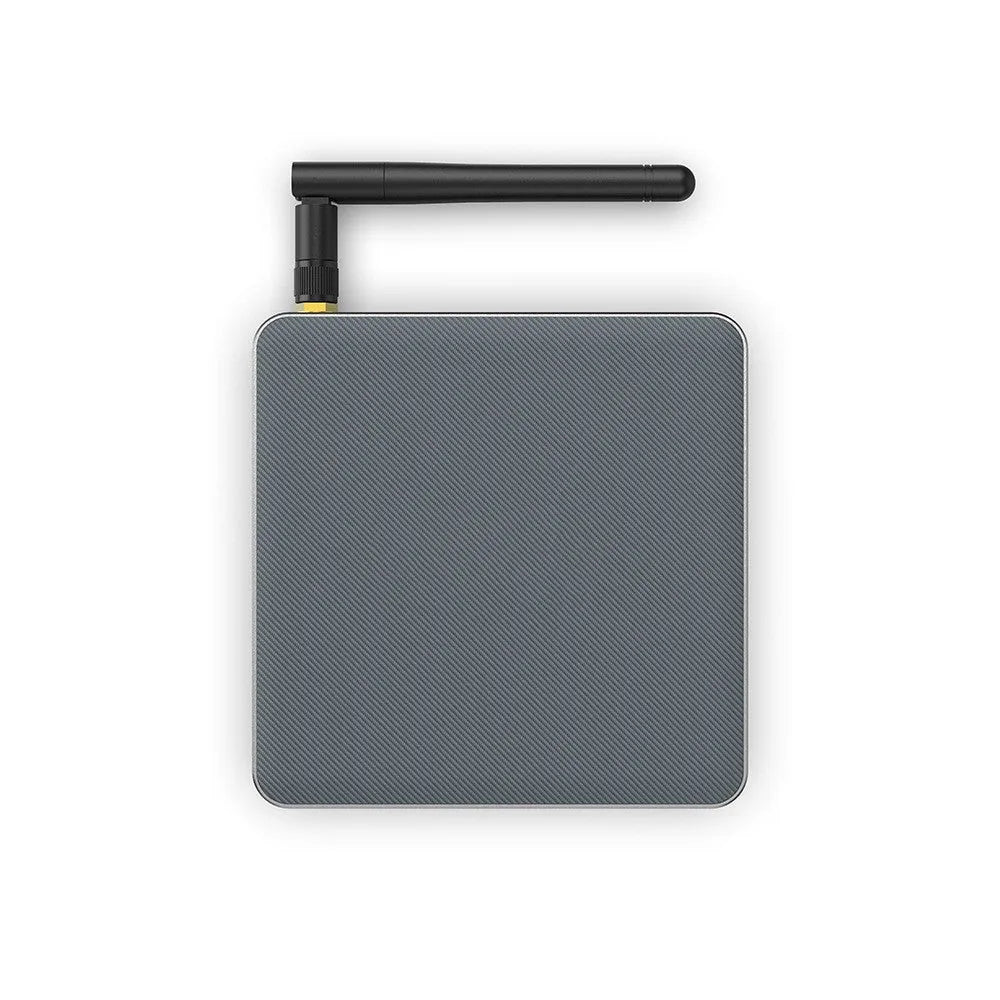 Black Android TV set-top box with remote control on a white background