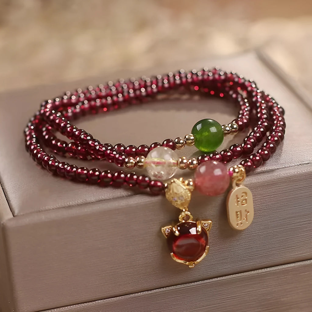 Purplish red garnet fox bracelet on an adjustable rope for women.