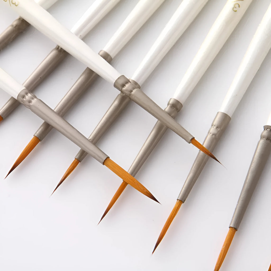 Set of 12 Pearl White artist paint brushes with nylon wool bristles, metal ferrules, and wooden handles.