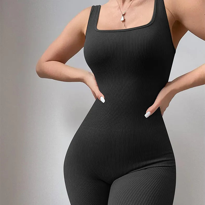 Women's black suspender tank top tights with button fastenings at shoulders showing full-length spandex construction