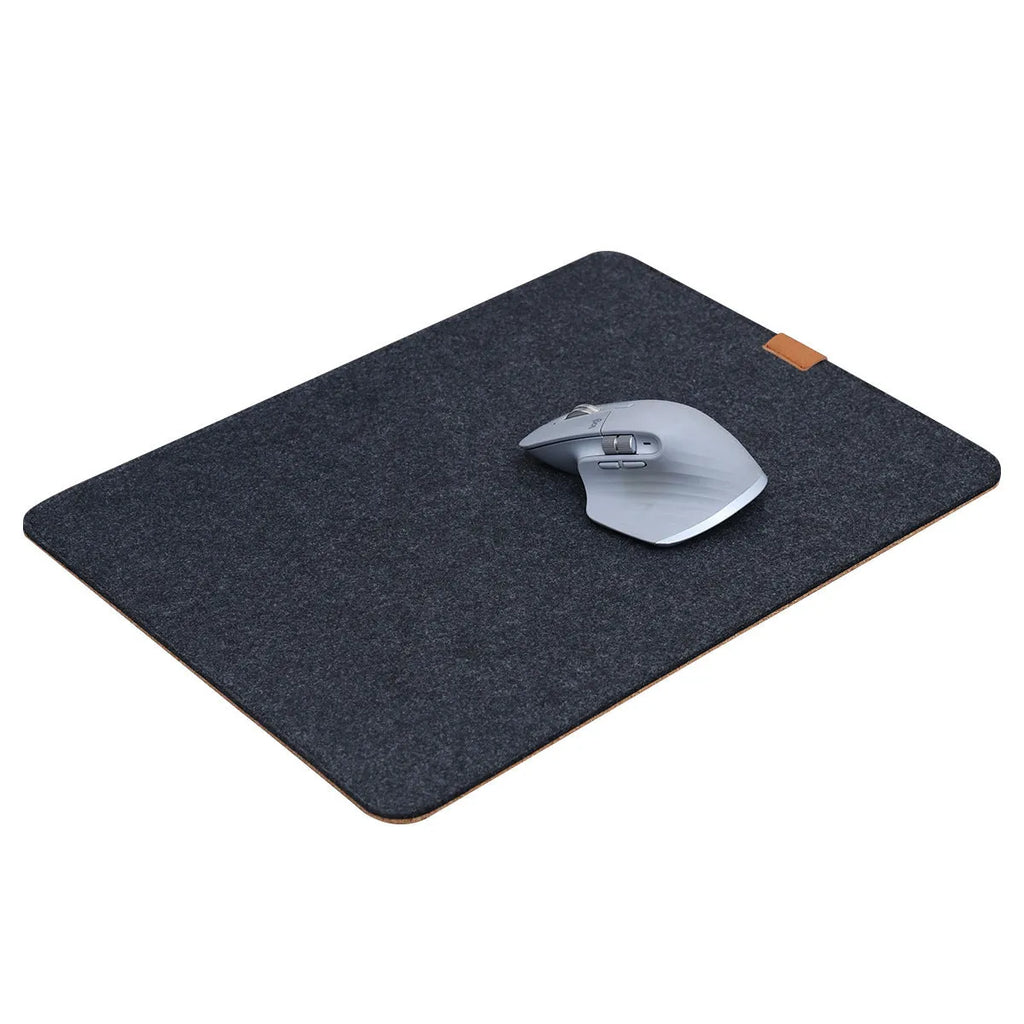 A winter warm felt cork office desk mat in a grey colour pattern, shown on a wooden desk with a mouse.