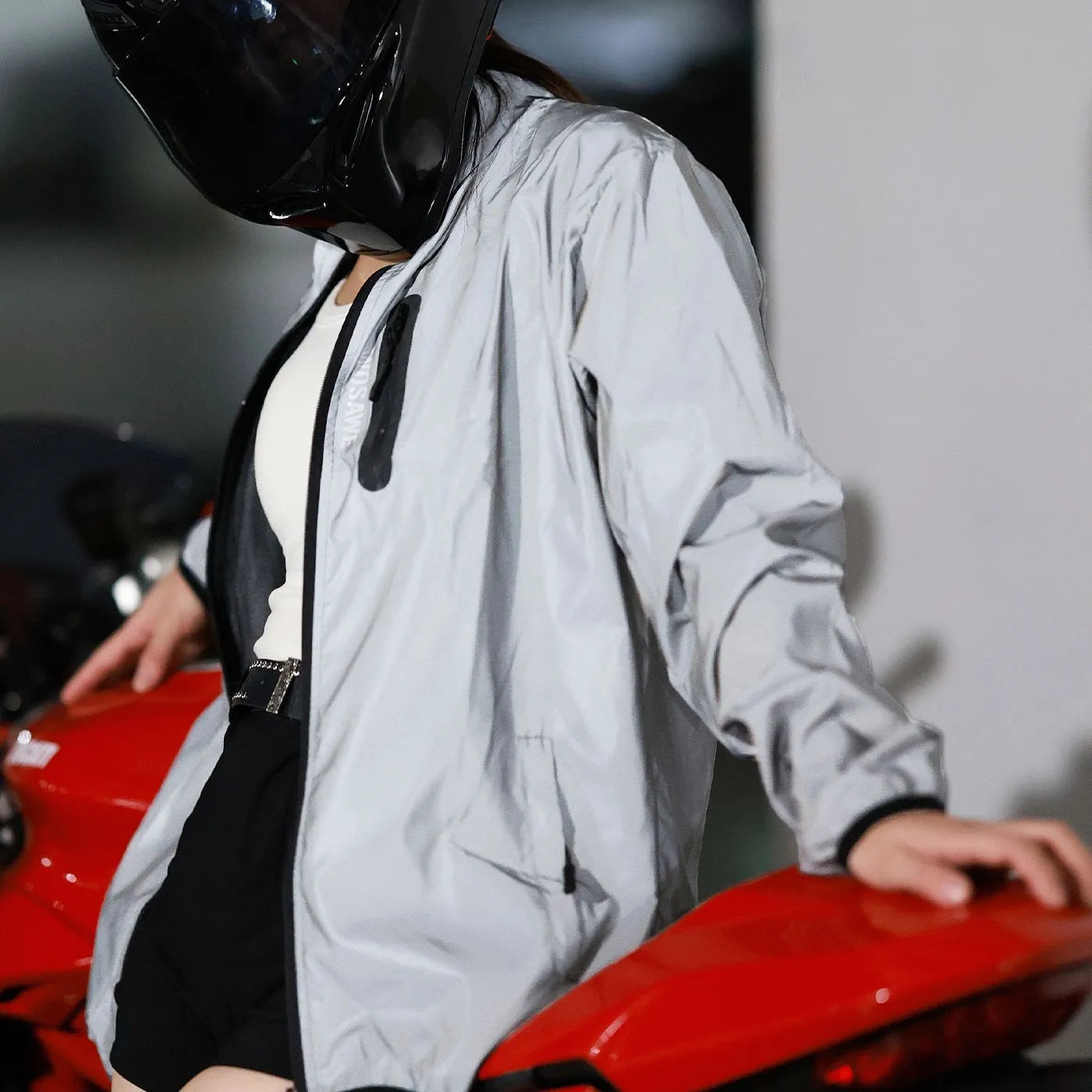 Silver waterproof polyester long-sleeved top displayed on a hanger, showing full sleeves and front closure.