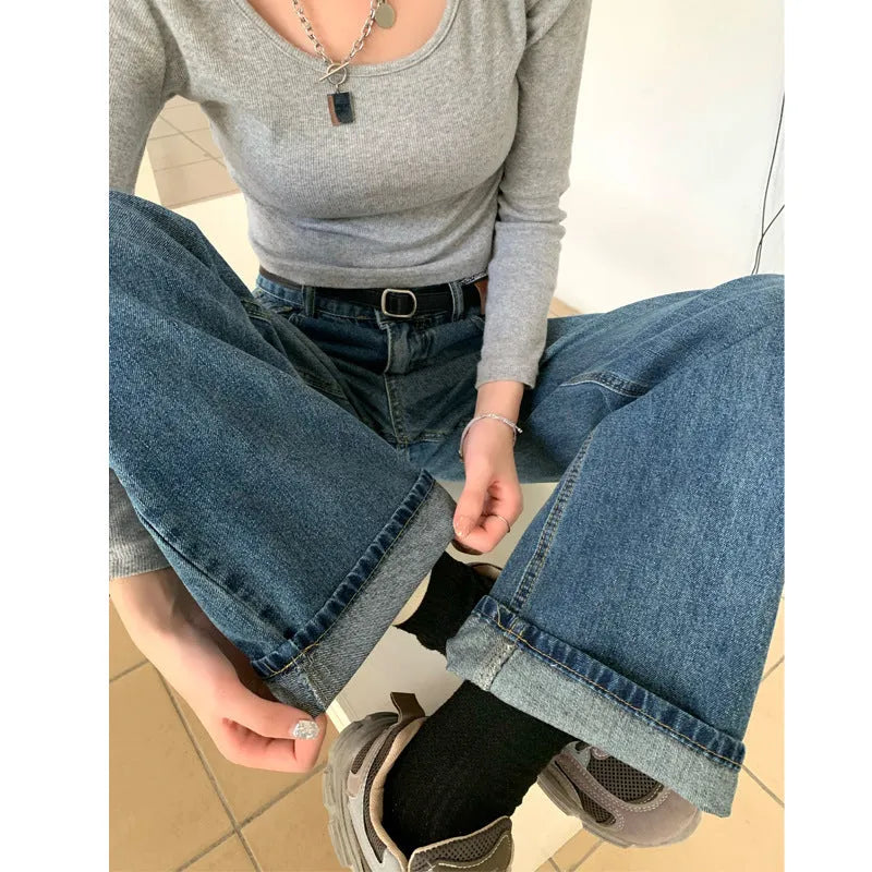 Women's retro blue straight leg jeans with a high waist, shown on a hanger.