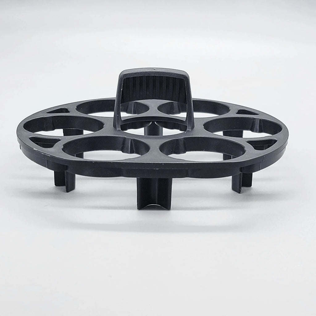 A black plastic egg holder rack on a kitchen countertop.