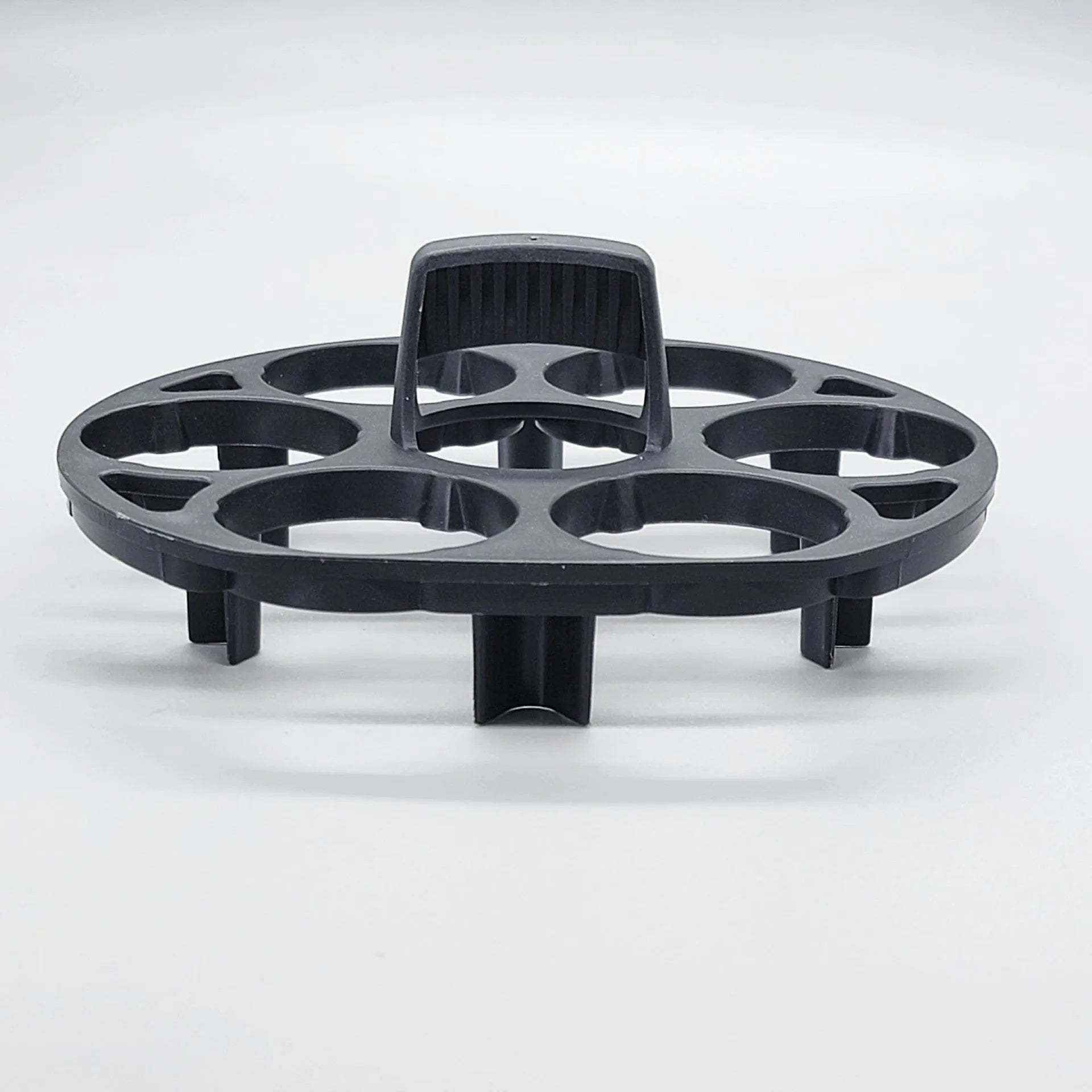 A black plastic egg holder rack on a kitchen countertop.