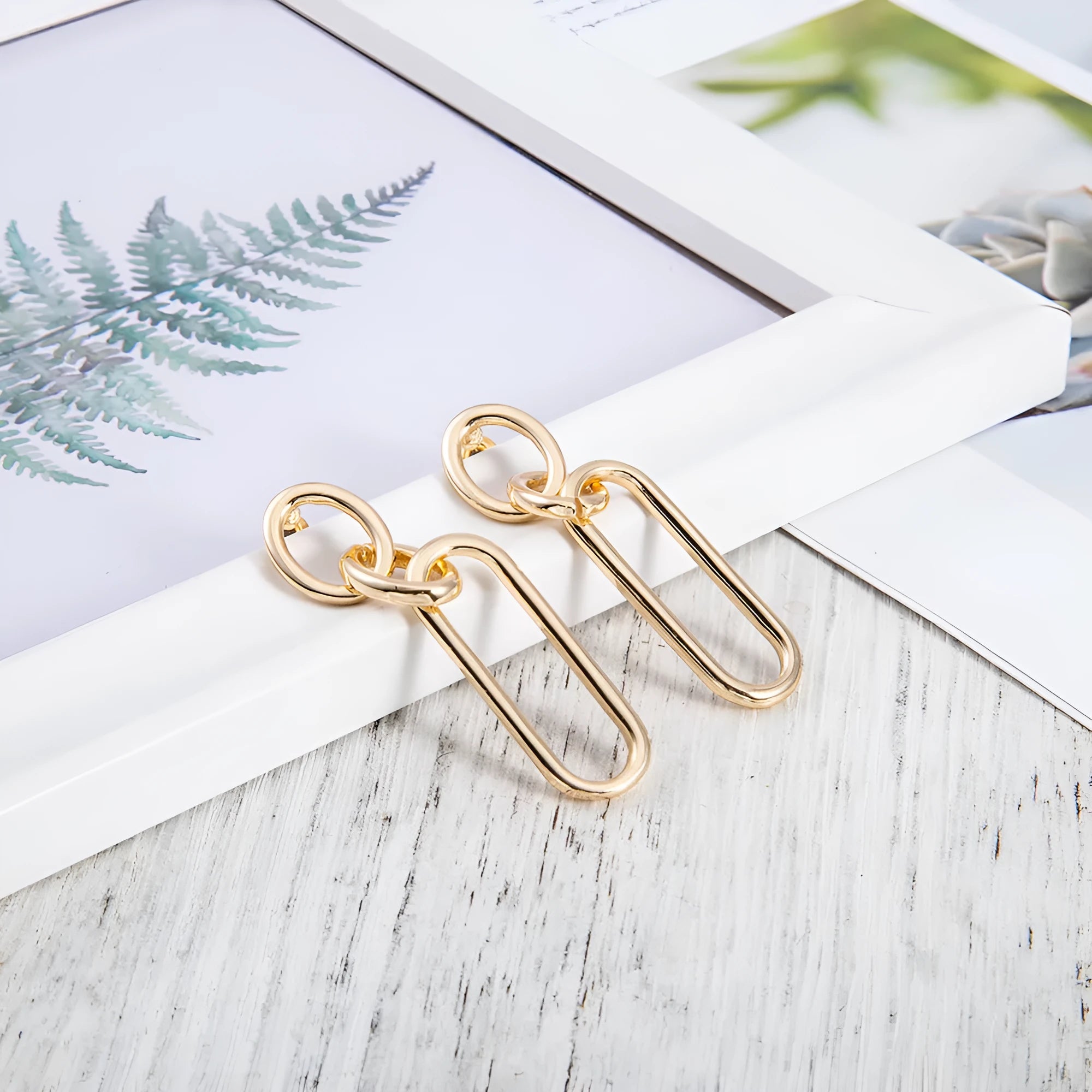 Sterling silver geometric hoop earrings with ring and line design elements
