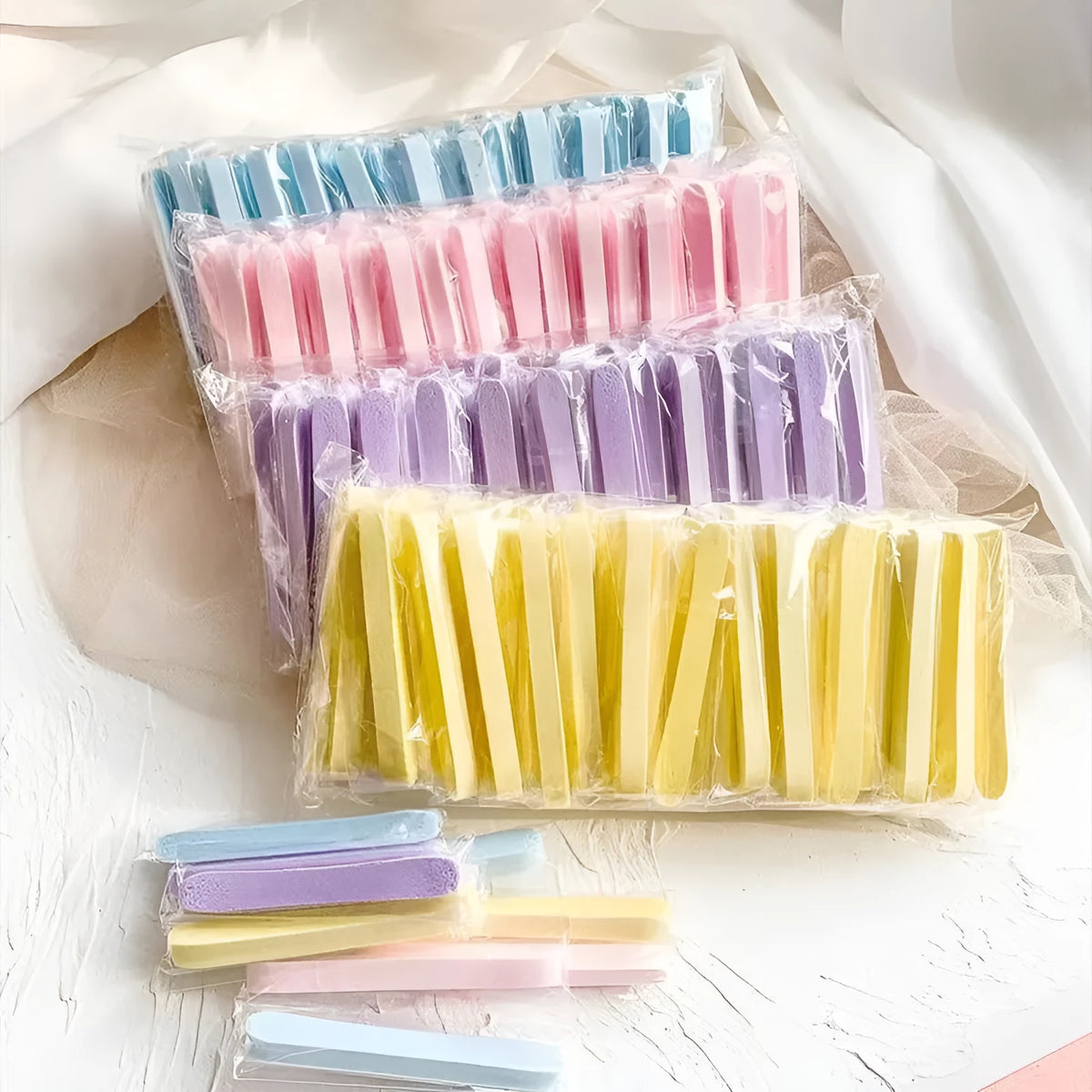 Compressed facial wipe puff in pink packaging, individually wrapped PVA sponge for single use cleansing