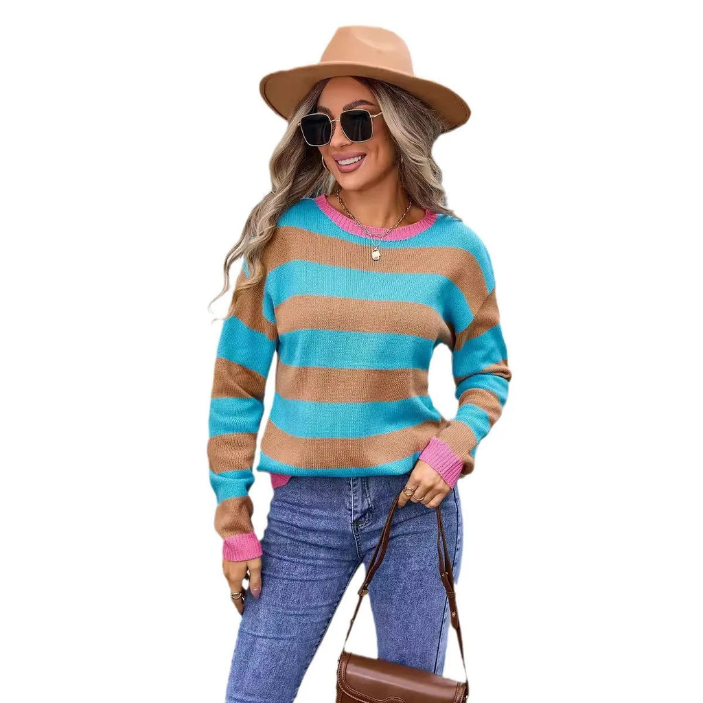 Women's loose blue acrylic knit sweater with round neck and long sleeves on a hanger.