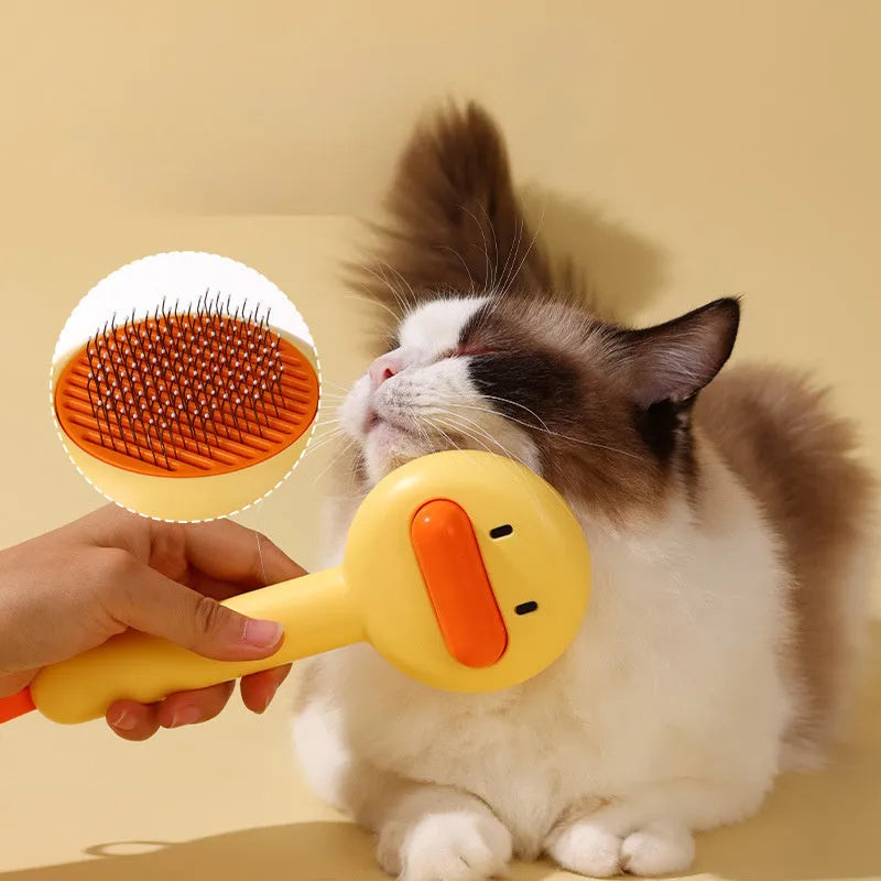 Small yellow duck-shaped pet grooming comb with open sections and needle teeth