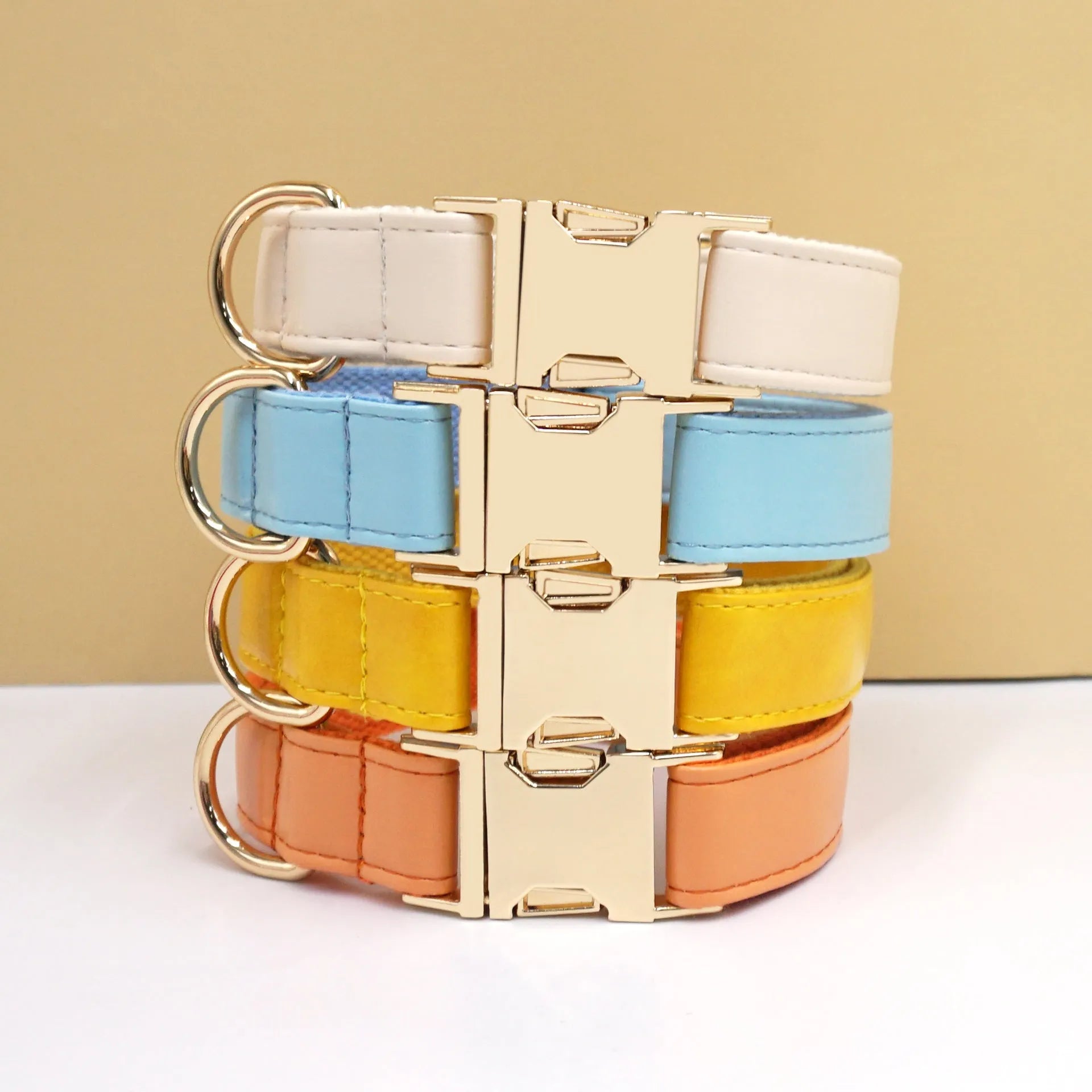 Solid colour leather dog collar shown in a selection of hues including caramel, dark blue and rose pink.