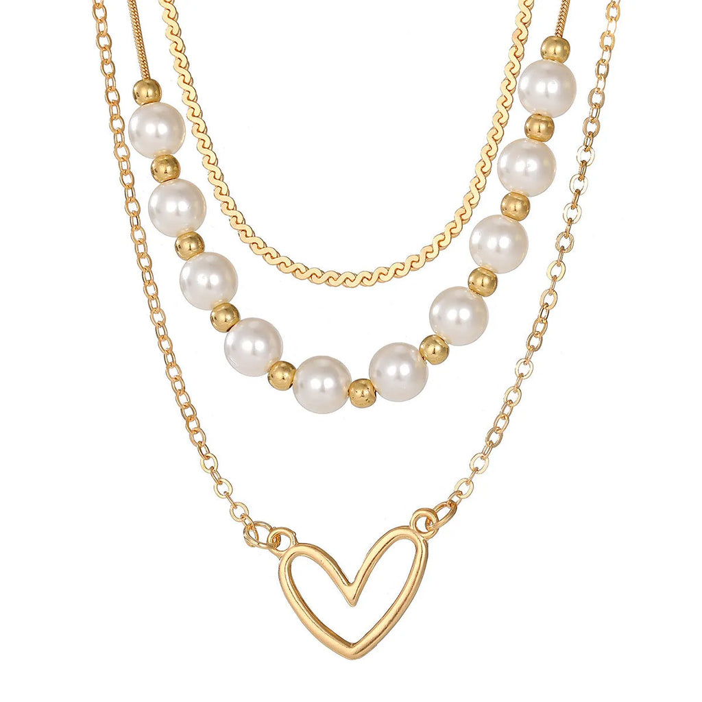 Gold electroplated vintage necklace with heart-shaped pendant on an adjustable pearl-style chain.