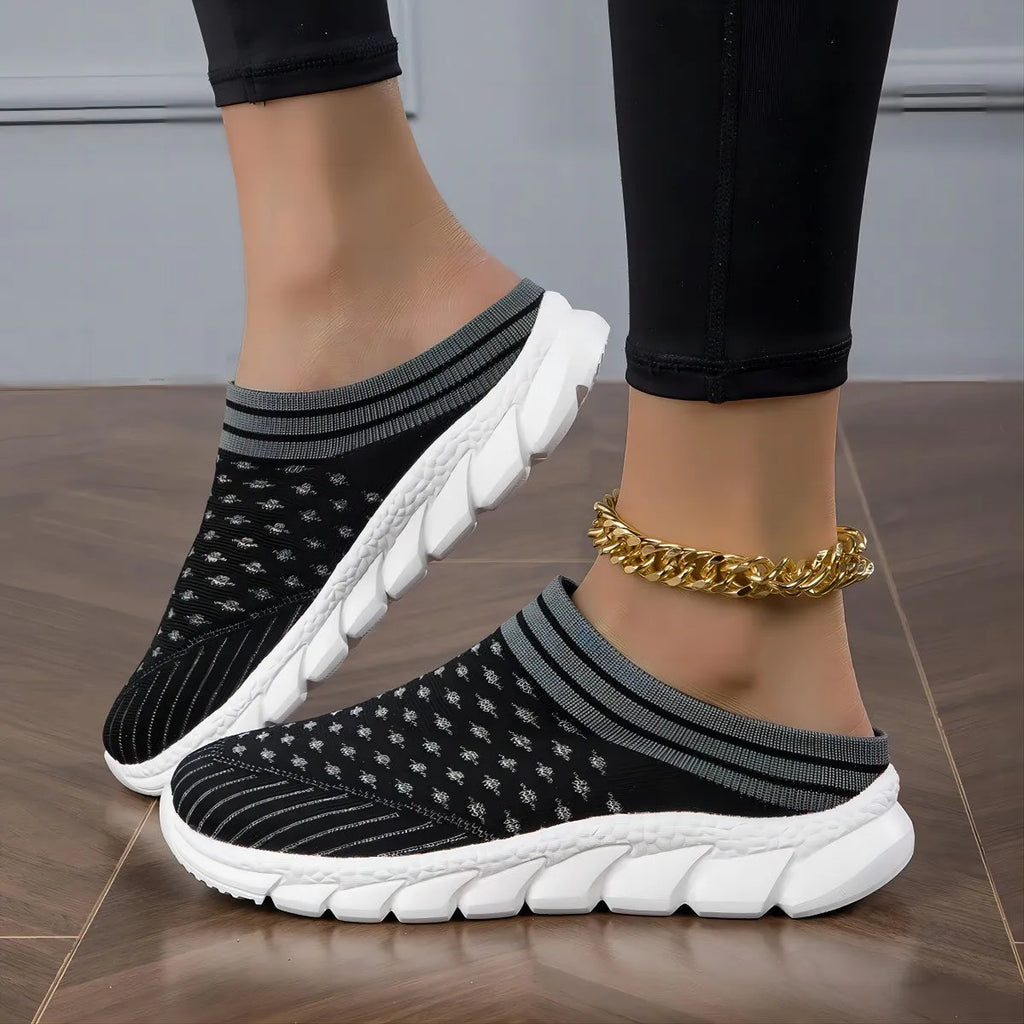 Women's black Flyknit semi-slipper shoe with striped pattern and raised sole