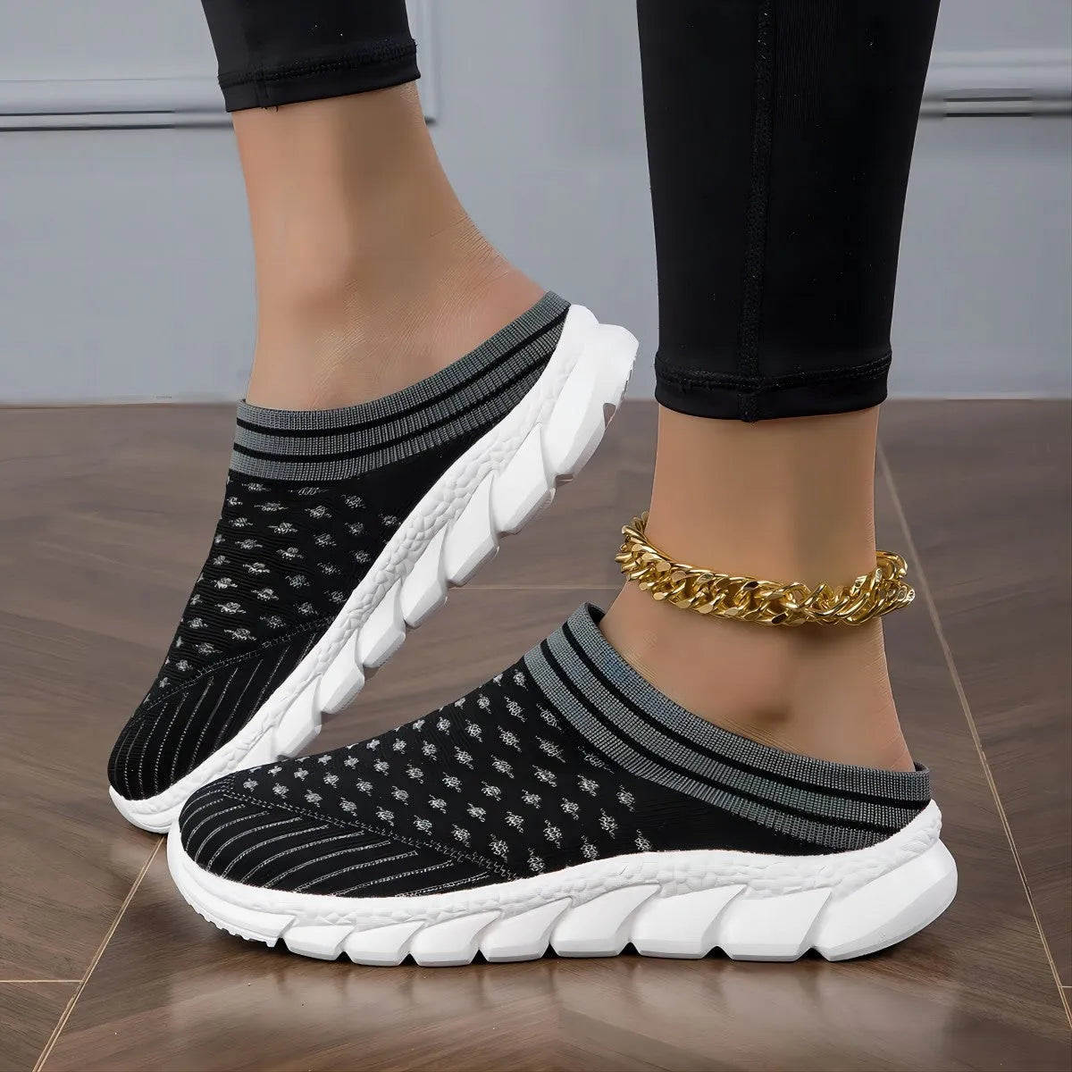 Women's black Flyknit semi-slipper shoe with striped pattern and raised sole