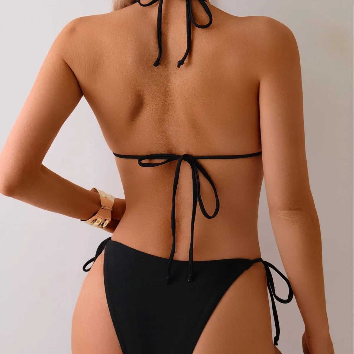 Black women's bikini swimsuit with metal bead decoration and split high-leg design