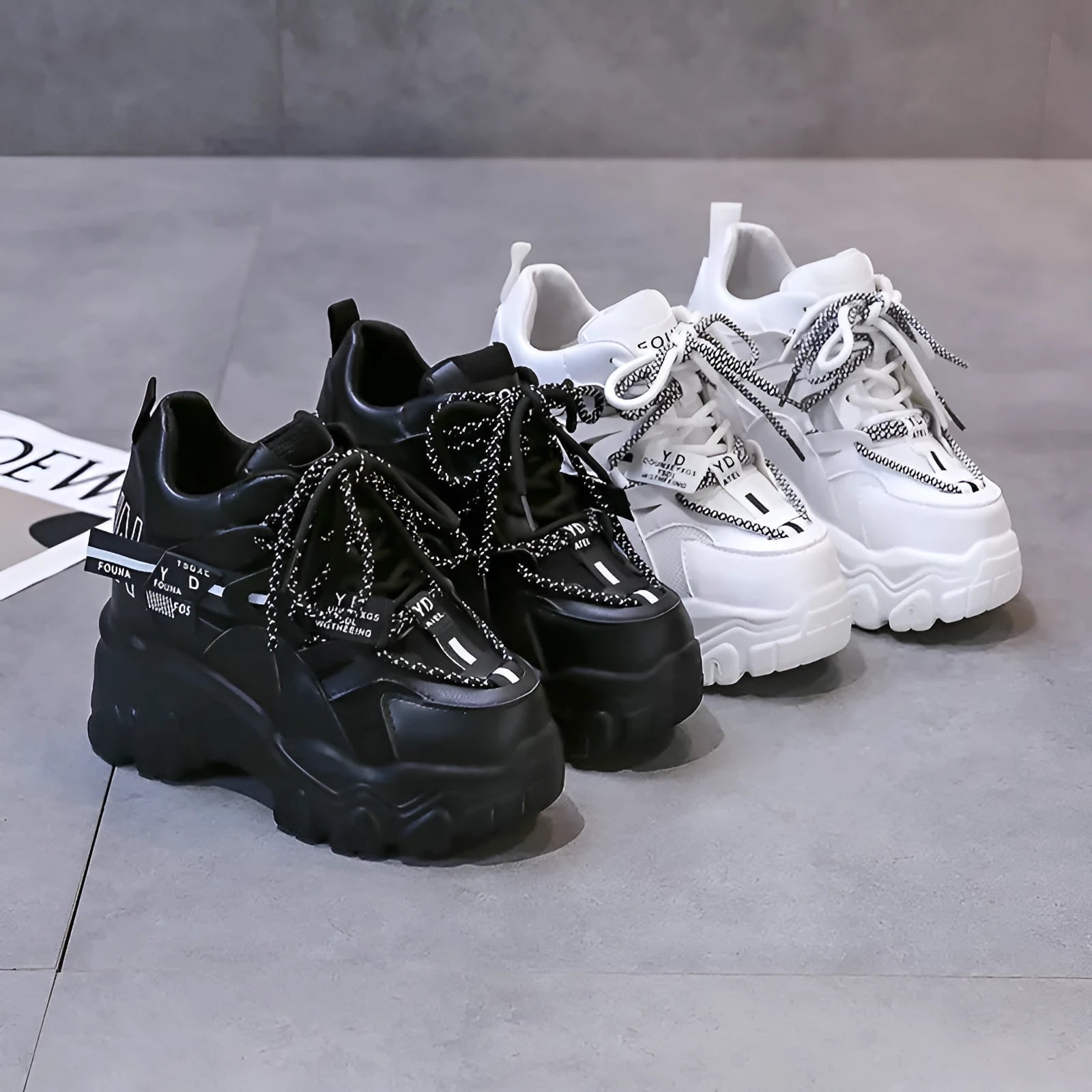 White women's low-top platform trainers with breathable mesh and a black cross-strap.