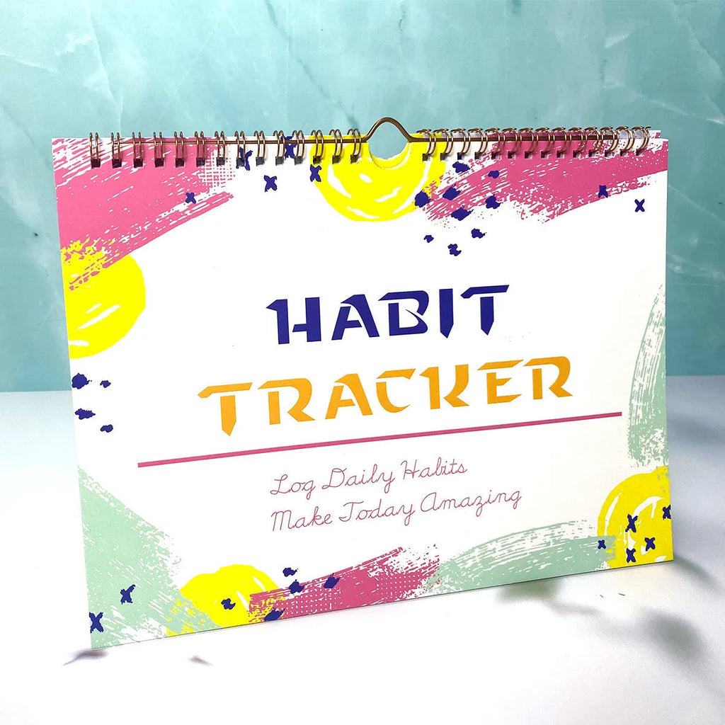 12-page habit tracking journal in pink and white, showing its 21cm by 28cm size.
