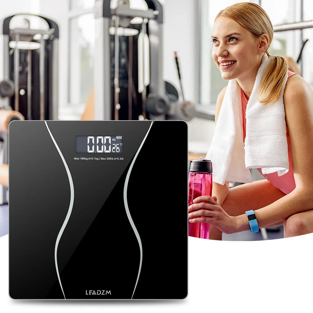 Matte black electronic body scale with digital display showing weight measurement