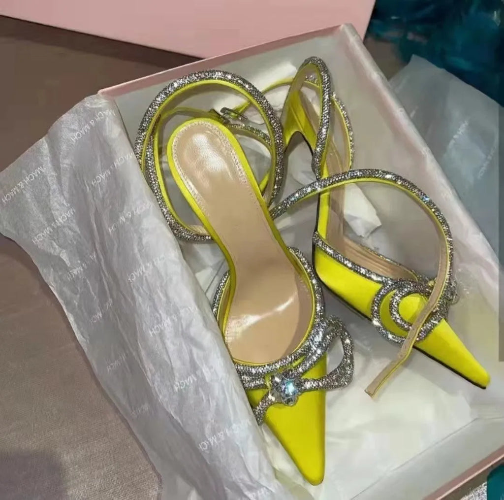 Women's black stiletto heel sandals with a silk bandage across the back and a buckle strap.