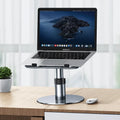 Adjustable silver aluminium car laptop stand with height settings and non-slip pads on a car seat.