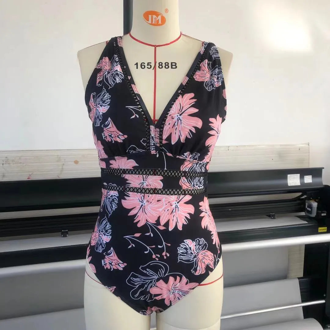 Women's black printed polyester plus-size bikini swimsuit shown on a hanger.